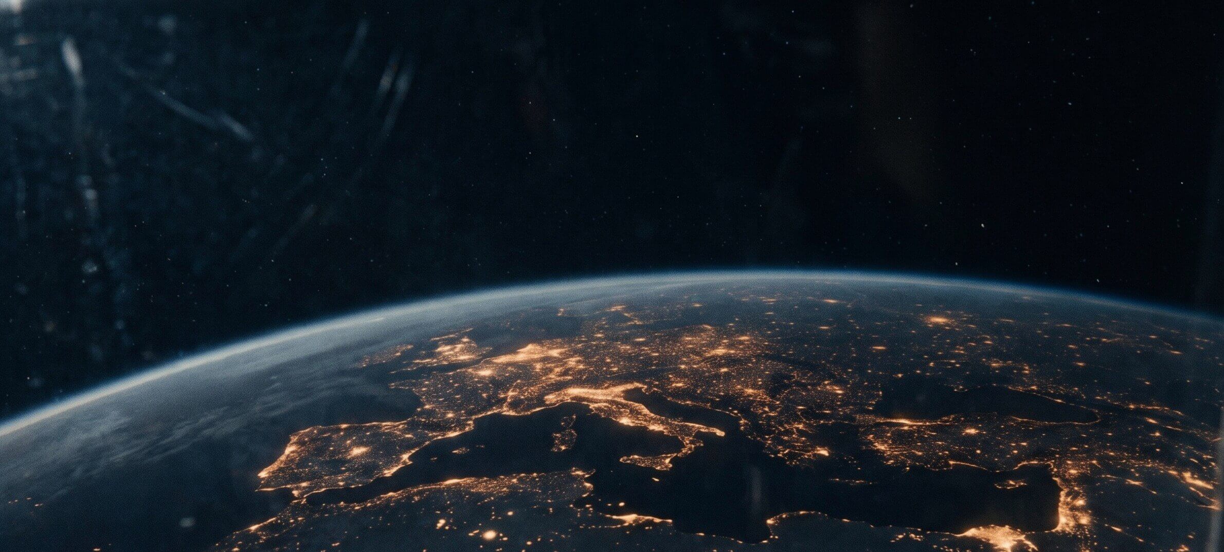 Europe and North Africa at night from orbit, city lights spread across the continent